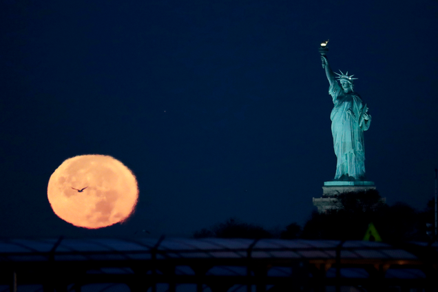 Moon setting near the Statue of Liberty, New York. Image: Julio Cortez/AP